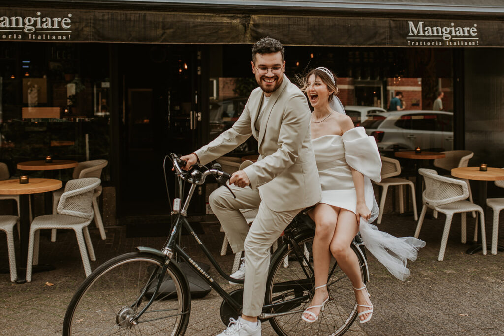 Bride and groom on a bike in Kleine Berg Eindhoven
